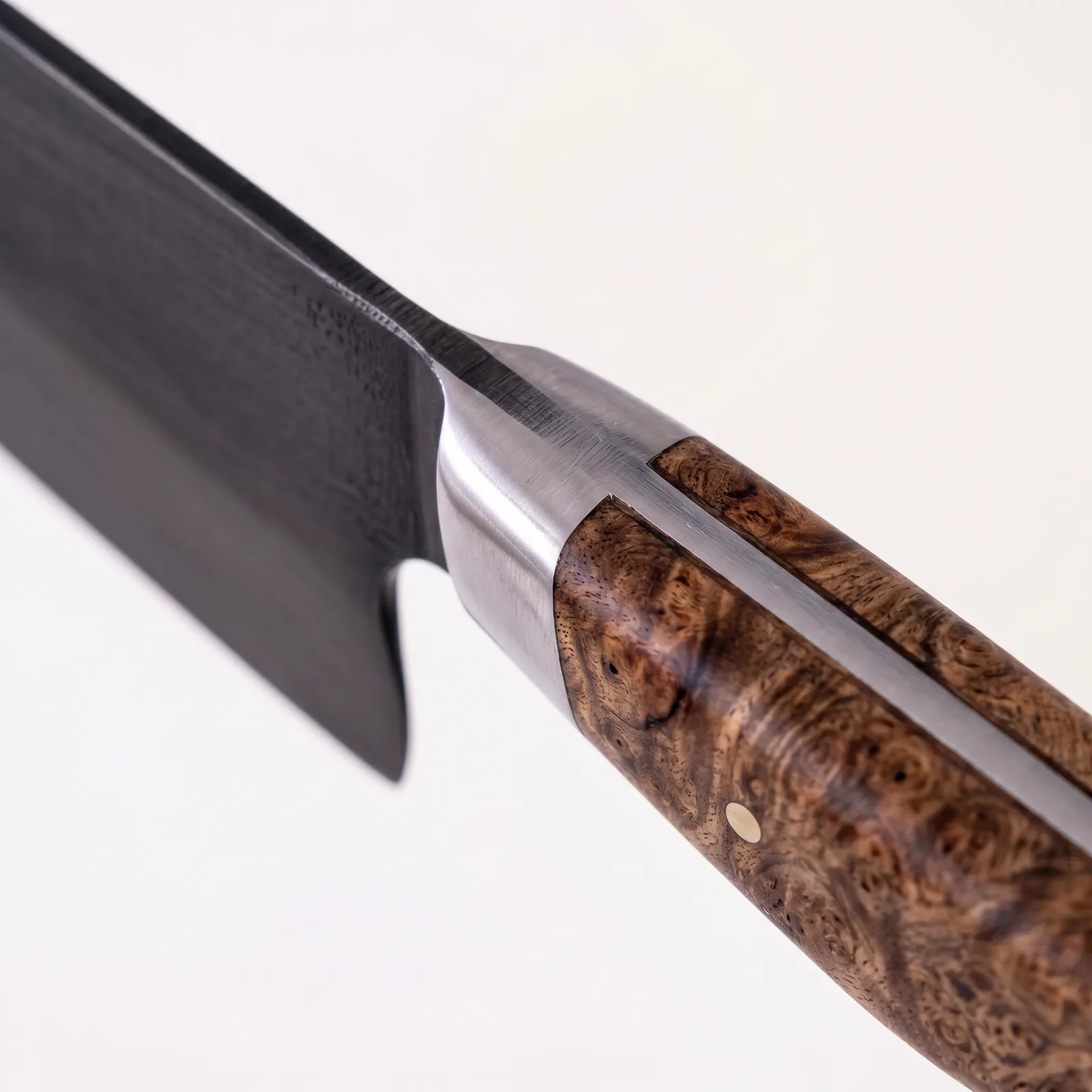 The cutting edge where blade, bolster and figured handle meet
