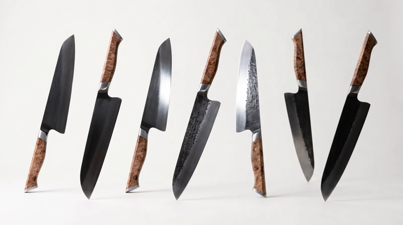 A row of hand-forged blades, each with its own finish and figured-hardwood handle
